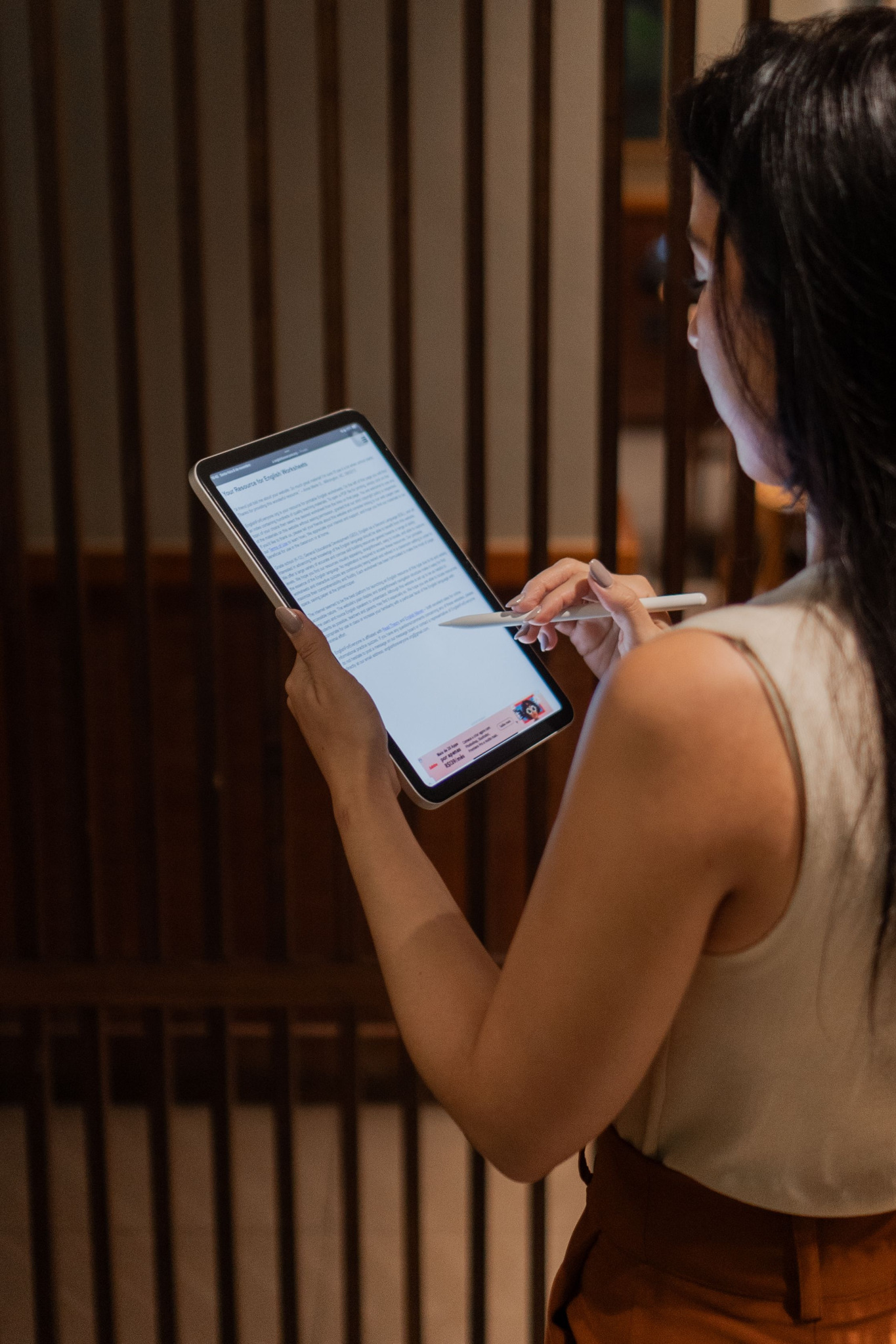 A person working on a tablet in an indoor workspace